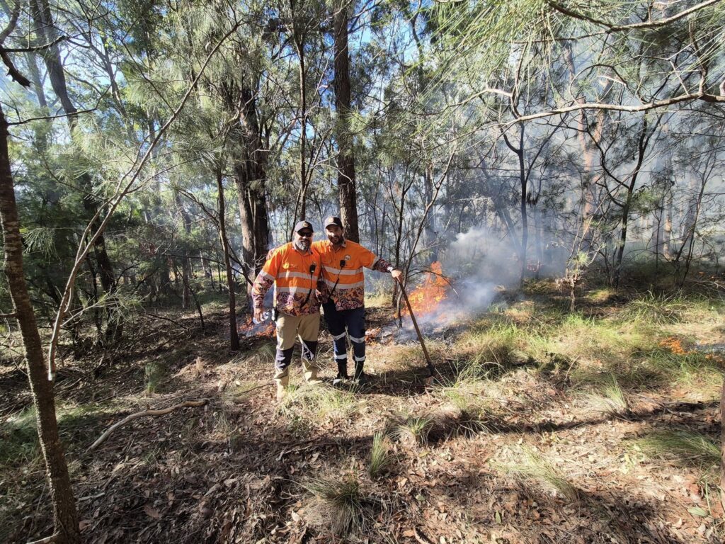 two firefighters posing during a controlled burn
